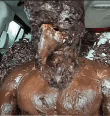 a man is covered in chocolate and looks like a statue