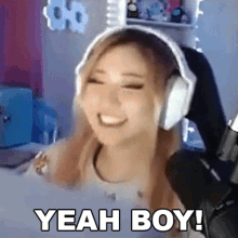 a woman wearing headphones is smiling and says " yeah boy "