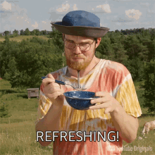 a man in a hat and tie dye shirt is eating from a bowl with the word refreshing written below him