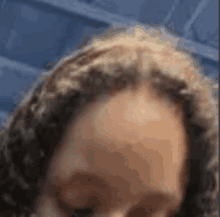 a close up of a woman 's head with curly hair .