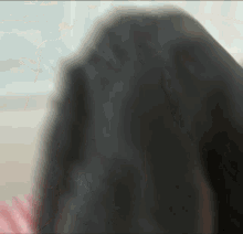 a blurry picture of a woman 's face with her hair visible