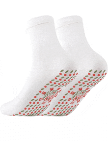 a pair of white socks with red and green dots on the bottom