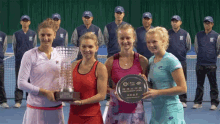 three tennis players are posing for a picture and one of them is holding a trophy that says denmark open