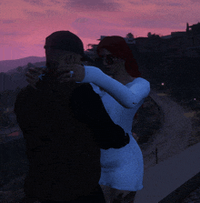 a man and a woman are hugging each other with a pink sky in the background