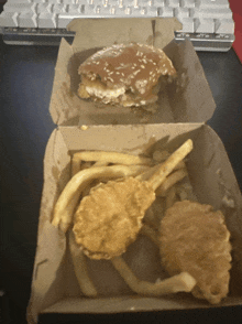 a hamburger and french fries in a box on a table