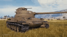 a tank is sitting in the middle of a field of tall grass .