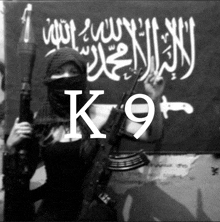 a man holding a gun in front of a flag that says k9 on it