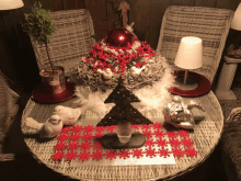 a table with christmas decorations on it including a small tree