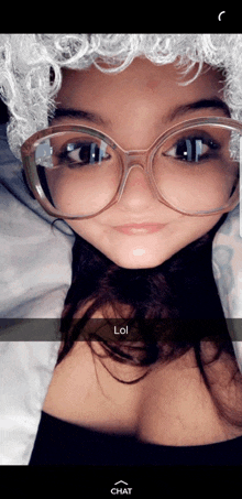 a girl wearing glasses and a white wig says lol on a snapchat