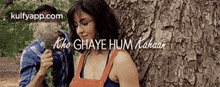 a man and a woman are leaning against a tree with the words " kho ghaye hum kakaar " written above them