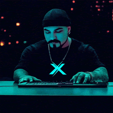 a man wearing a black shirt with a glowing x on it