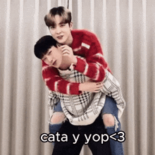 a man is carrying another man on his back with the words cata y yop < 3 below them