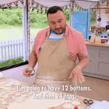 a man in an apron is standing in front of a table with a bowl of dough .