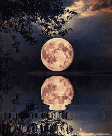 a full moon rises over a body of water with a reflection of it