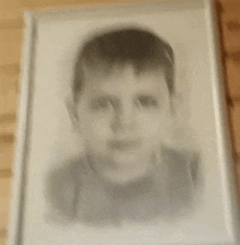 a black and white photo of a young boy 's face