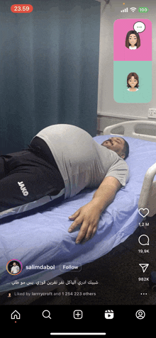 a man with a large belly is laying in a hospital bed and the time is 23:59