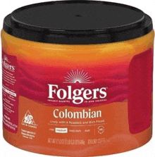 a can of folgers colombian ground coffee is sitting on a table .