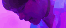 a close up of a person 's face with a purple background .