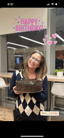 a woman is holding a cake in front of a happy birthday message