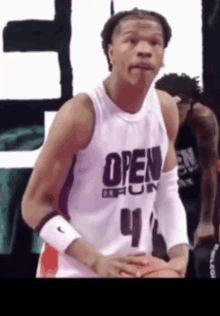 a basketball player wearing a white jersey with the word open on it