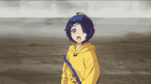 a girl in a yellow hoodie with a flower on it