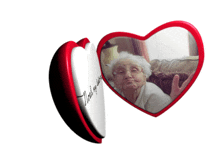 a heart shaped mirror with a picture of an elderly woman in it