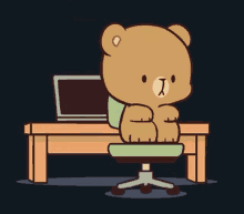 a teddy bear is sitting at a desk with a laptop in the background