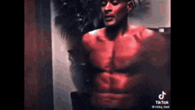 a shirtless man with red muscles is standing in front of a mirror .