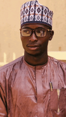 a man wearing glasses and a hat with a pattern on it