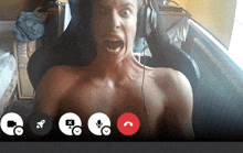 a shirtless man wearing headphones is making a funny face in a video call