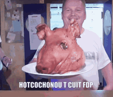 a man is holding a plate with a pig head on it and the words hotcochonout cuit fdp below