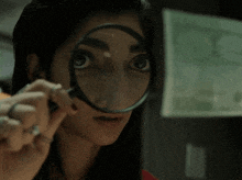 a woman is looking through a magnifying glass at her face