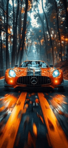 an orange mercedes benz is driving down a road in the woods