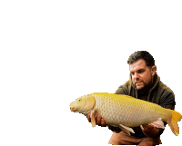 a man is holding a large fish in his hands against a white background