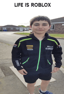 a young boy wearing a black jacket with yamaha and stanley logos on the sleeves