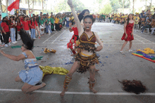 a group of people are dancing on a court and one of them is wearing a red dress