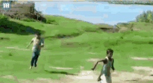 two young boys are playing soccer in a field .