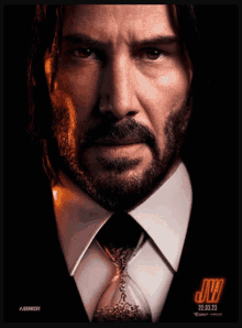 a movie poster for john wick shows a man in a suit