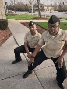 a man and a woman squatting on a sidewalk