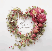 a heart shaped wreath with the word october in the middle