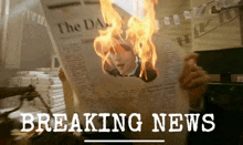 a person is reading a newspaper with a picture of a man on it and the headline breaking news