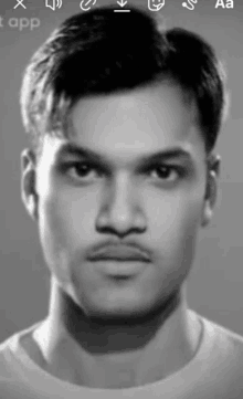 a black and white photo of a man 's face with a mustache