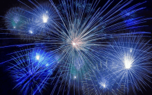 a fireworks display with blue and white fireworks