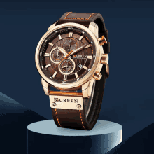 a brown curren watch with a brown leather band