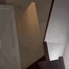 a staircase in a house with a light coming through the ceiling