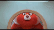 a red teddy bear looks at itself in a mirror