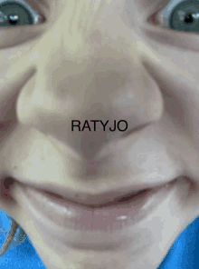 a close up of a child 's face with the word ratjo written on it