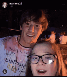 a girl wearing glasses stands next to a boy wearing a shirt that says ' avalane22 2021 '