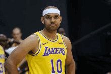 a basketball player wearing a yellow lakers jersey