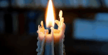 a close up of a candle with a flame coming out of it .